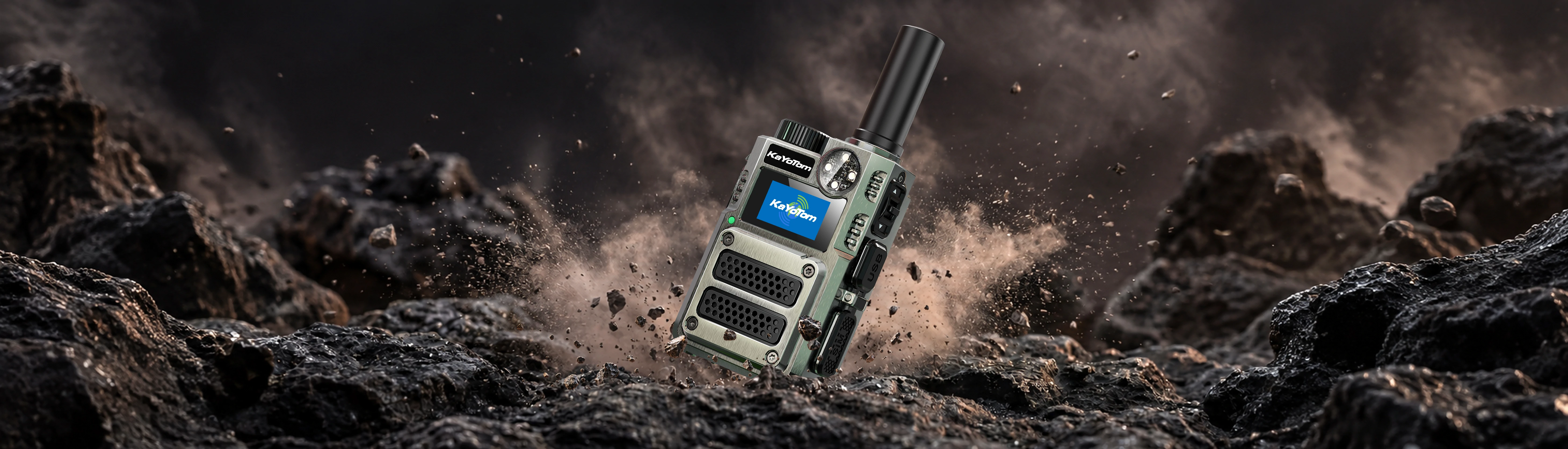 KayoTom M12 rugged cellular two-way radio displayed on rocky terrain with flying dust and debris background