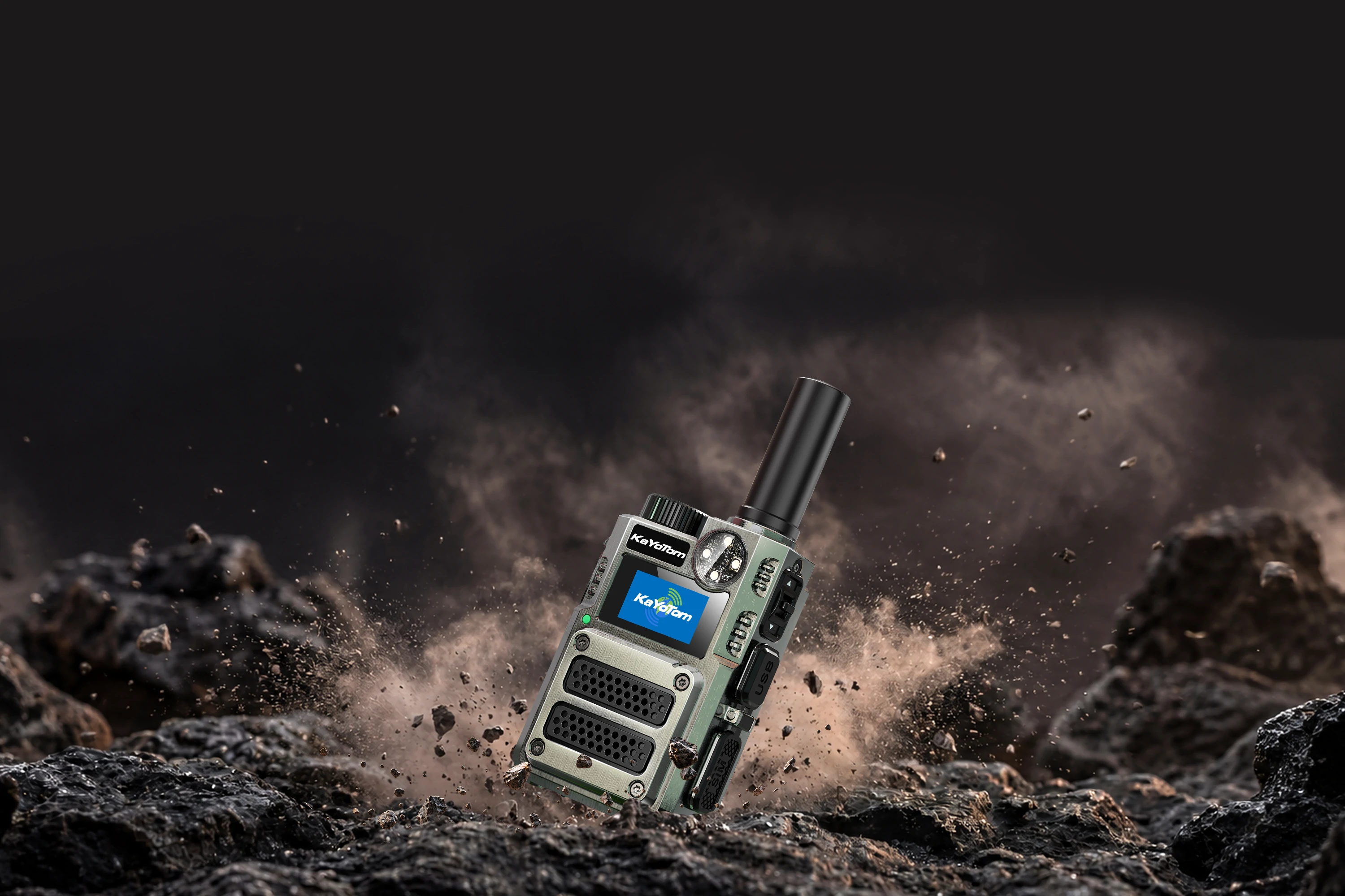 KayoTom M12 tactical green rugged two-way radio showcased against a dramatic rock and debris background