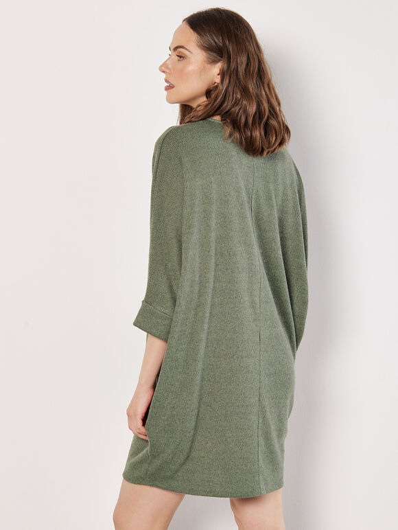 A greenish-brown knitted dress in a cocoon shape with ruffles along the edges