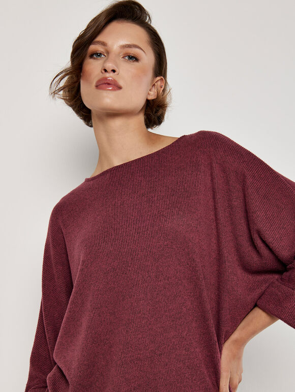 A wine-red knitted dress with ruffled edges and a tubular shape