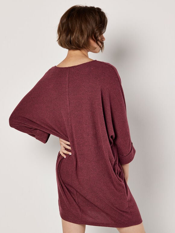 A wine-red knitted dress with ruffled edges and a tubular shape