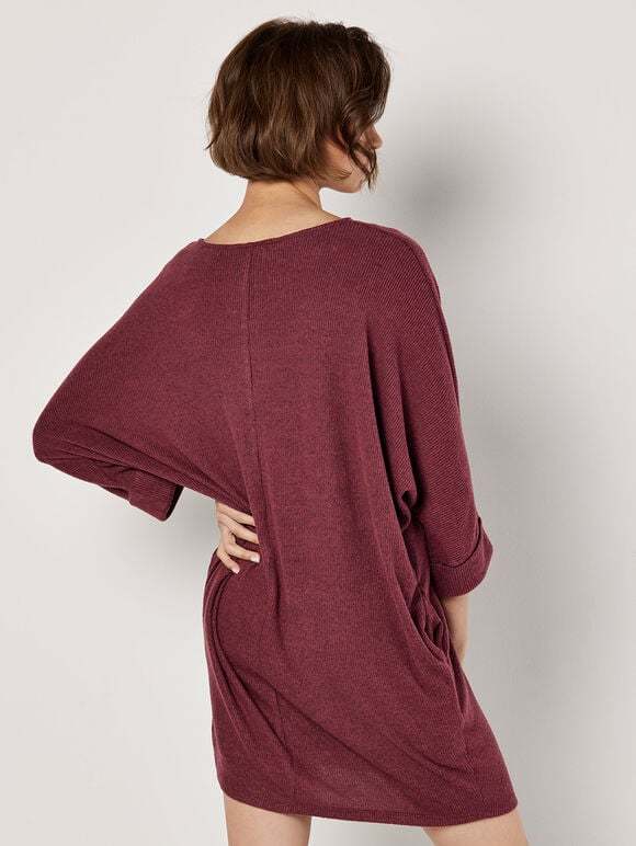 A wine-red knitted dress with ruffled edges and a tubular shape