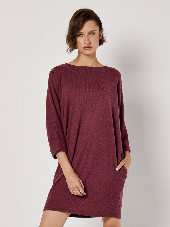 A wine-red knitted dress with ruffled edges and a tubular shape