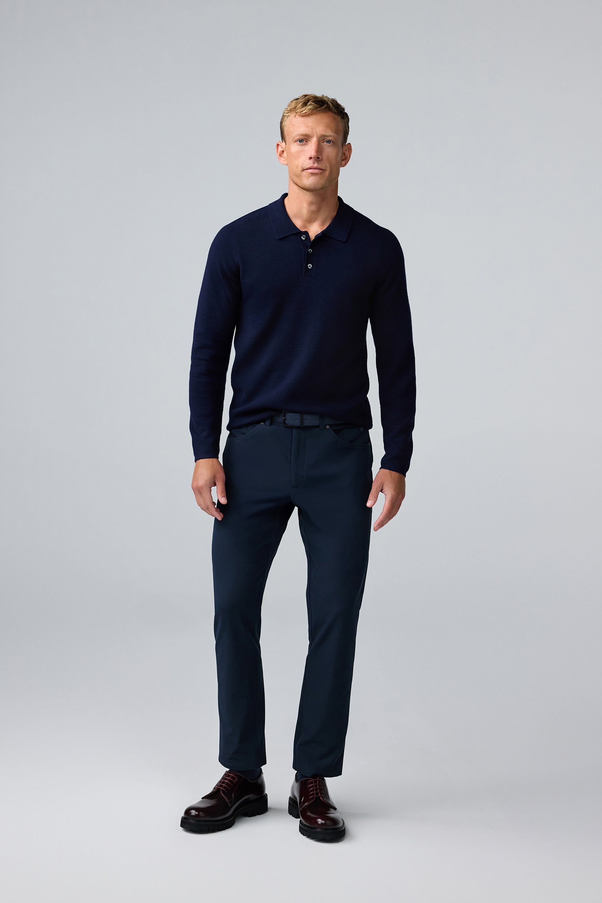Full body front view of man wearing Tech Merino Sweater Polo in Total Eclipse