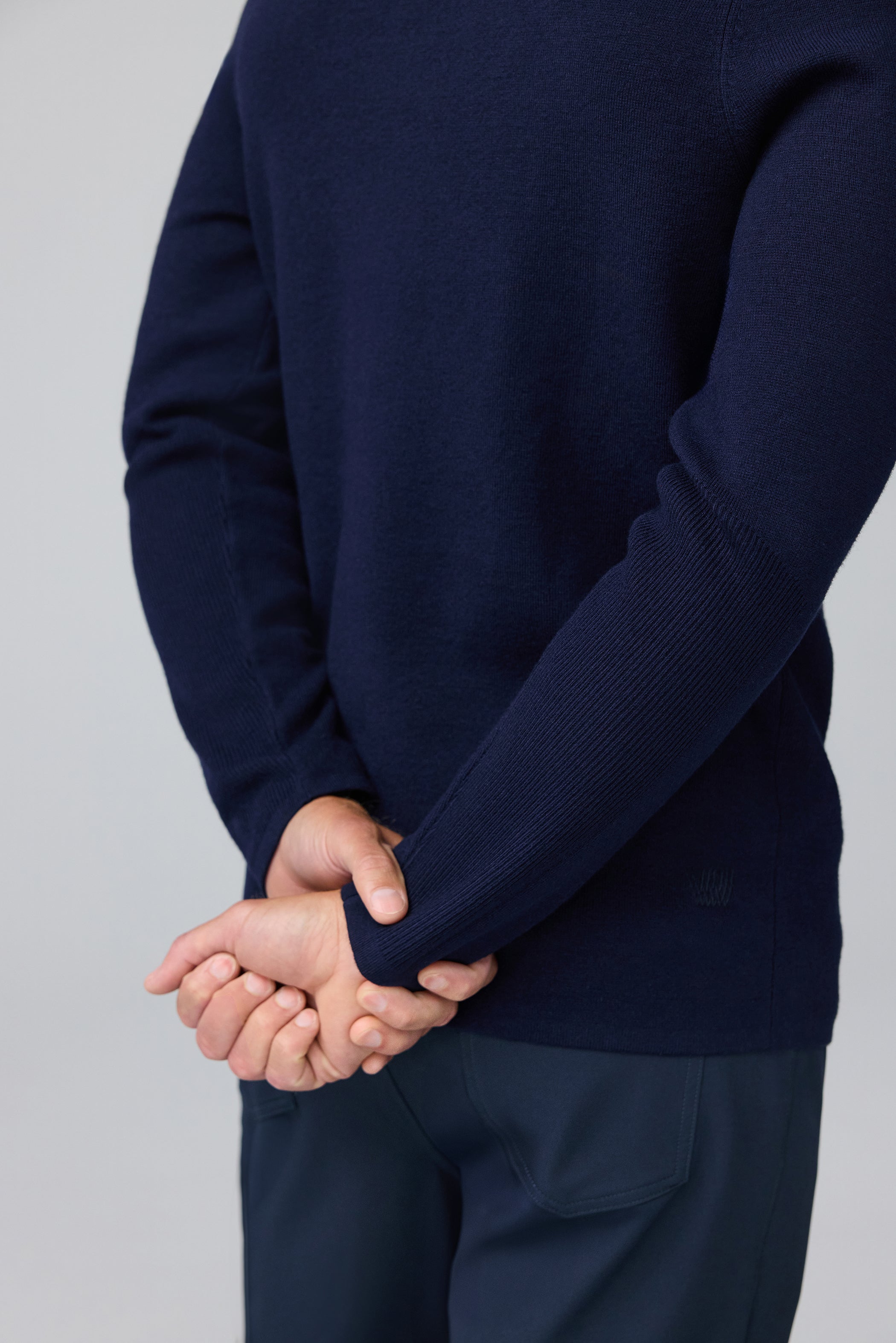 Detail back view of man wearing Tech Merino Sweater Polo in Total Eclipse