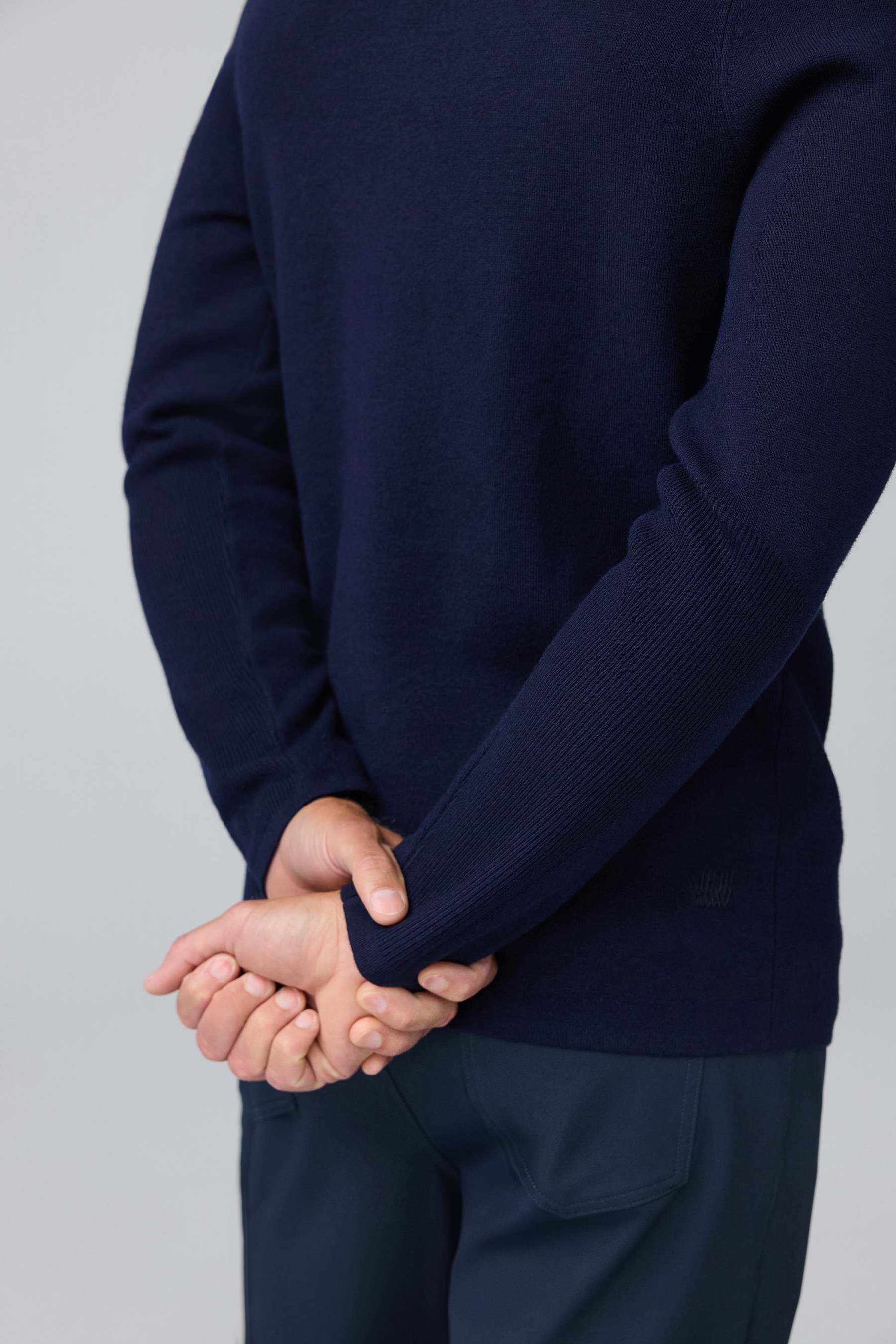 Detail back view of man wearing Tech Merino Sweater Polo in Total Eclipse