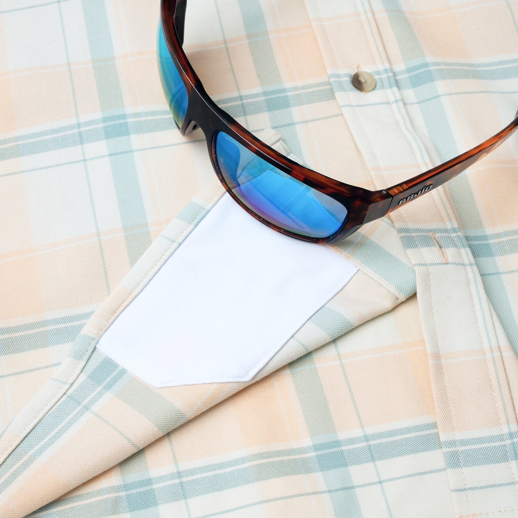 sunglasses with lens cleaner on shirt