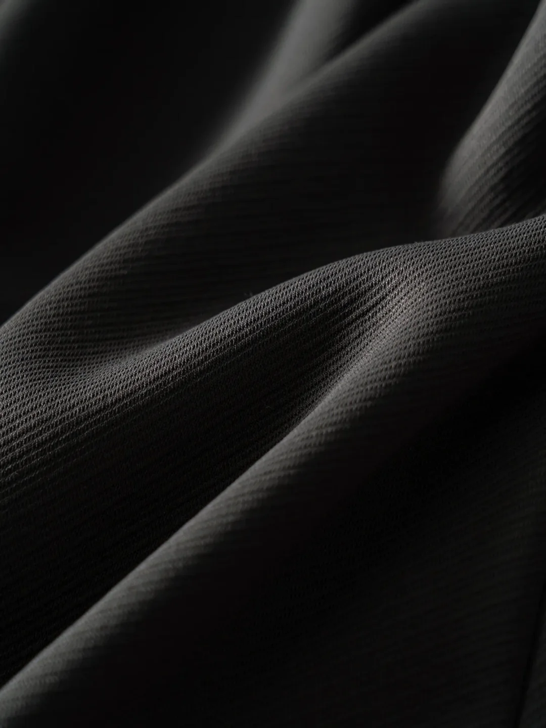 Close view of dark breathable jacket fabric