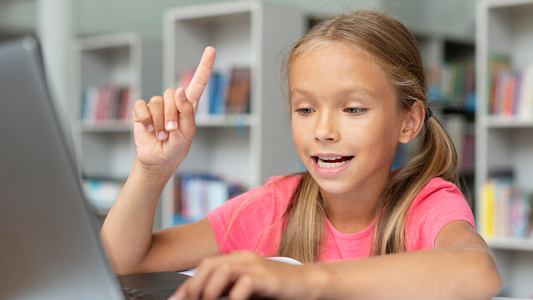 A girl is learning to sing from the computer