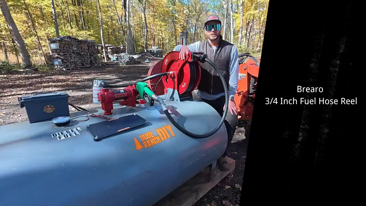 A person using a Brearo 3/4 inch fuel hose reel with a tractor, demonstrating its high-efficiency design for fuel transfer in outdoor settings.
