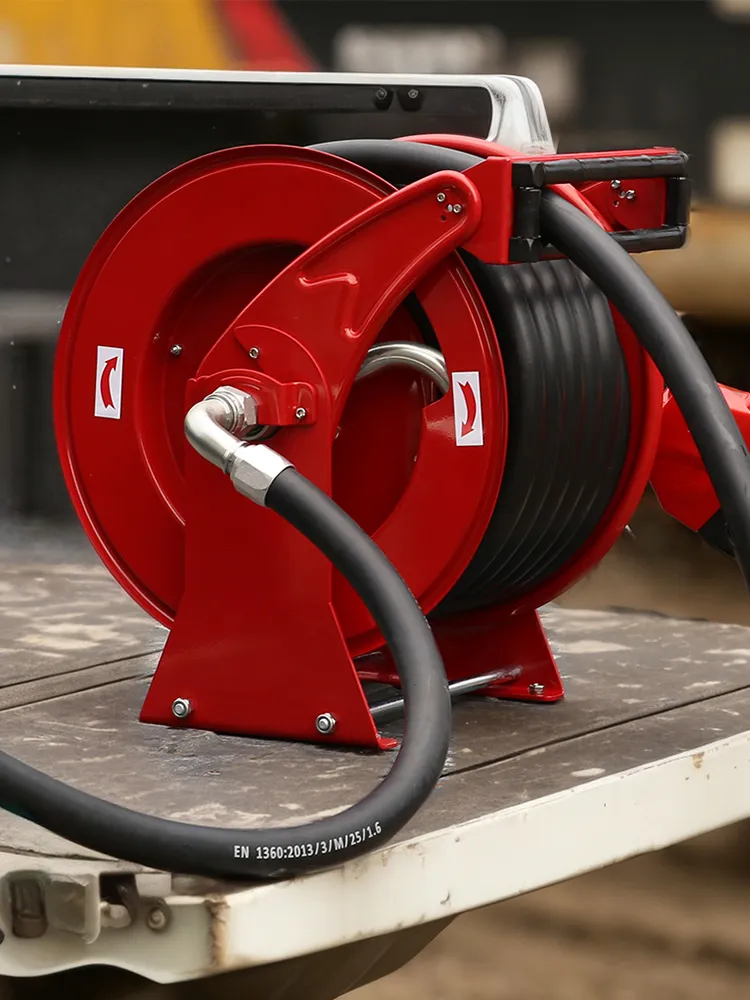 Red fuel transfer hose reel and pump system mounted on a sturdy platform, designed for efficient oil transfer applications in industrial and everyday use, with durable construction and high performance.