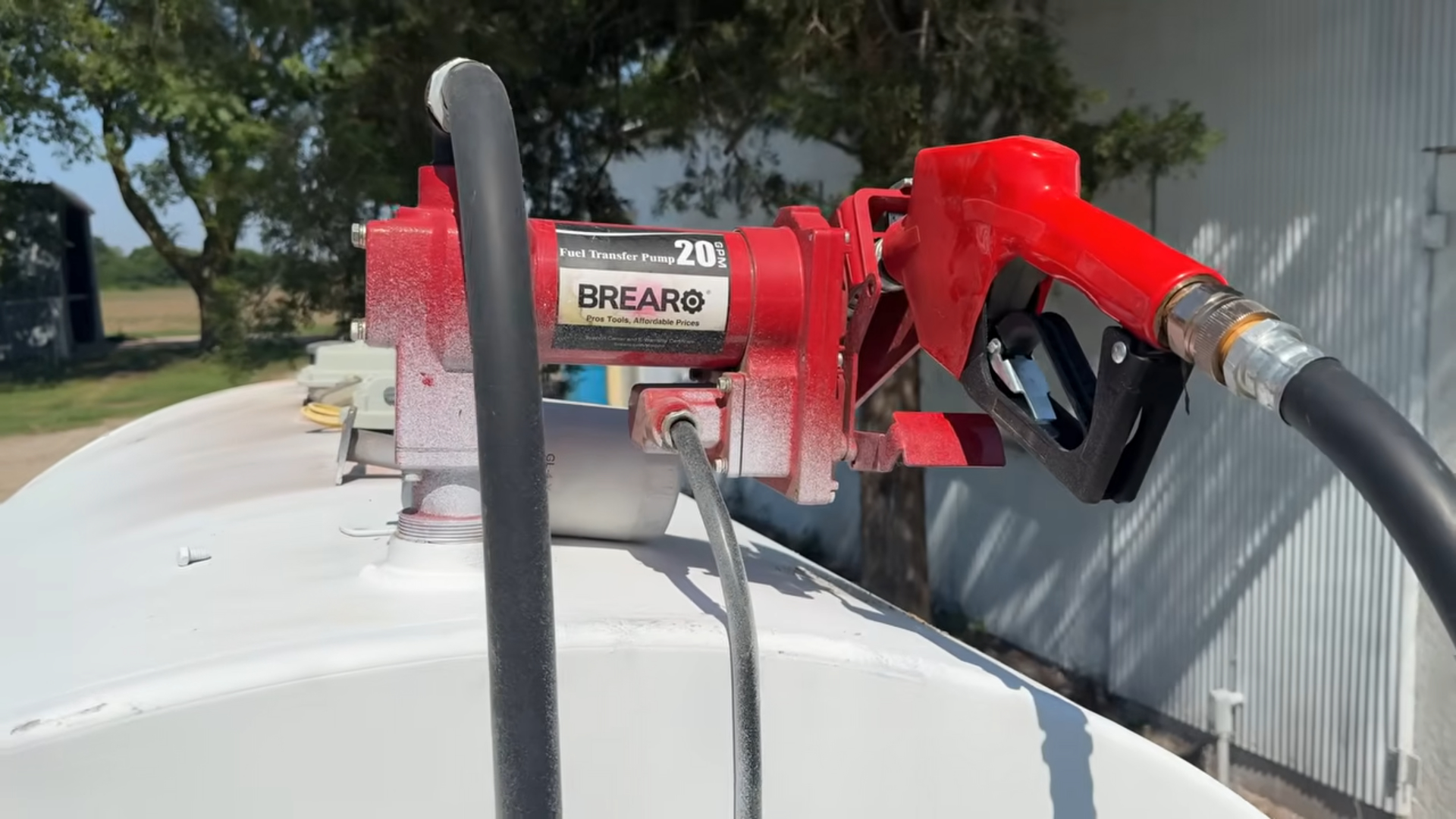 Close-up of a Brearo 20 GPM diesel fuel transfer pump mounted on a farm fuel tank.