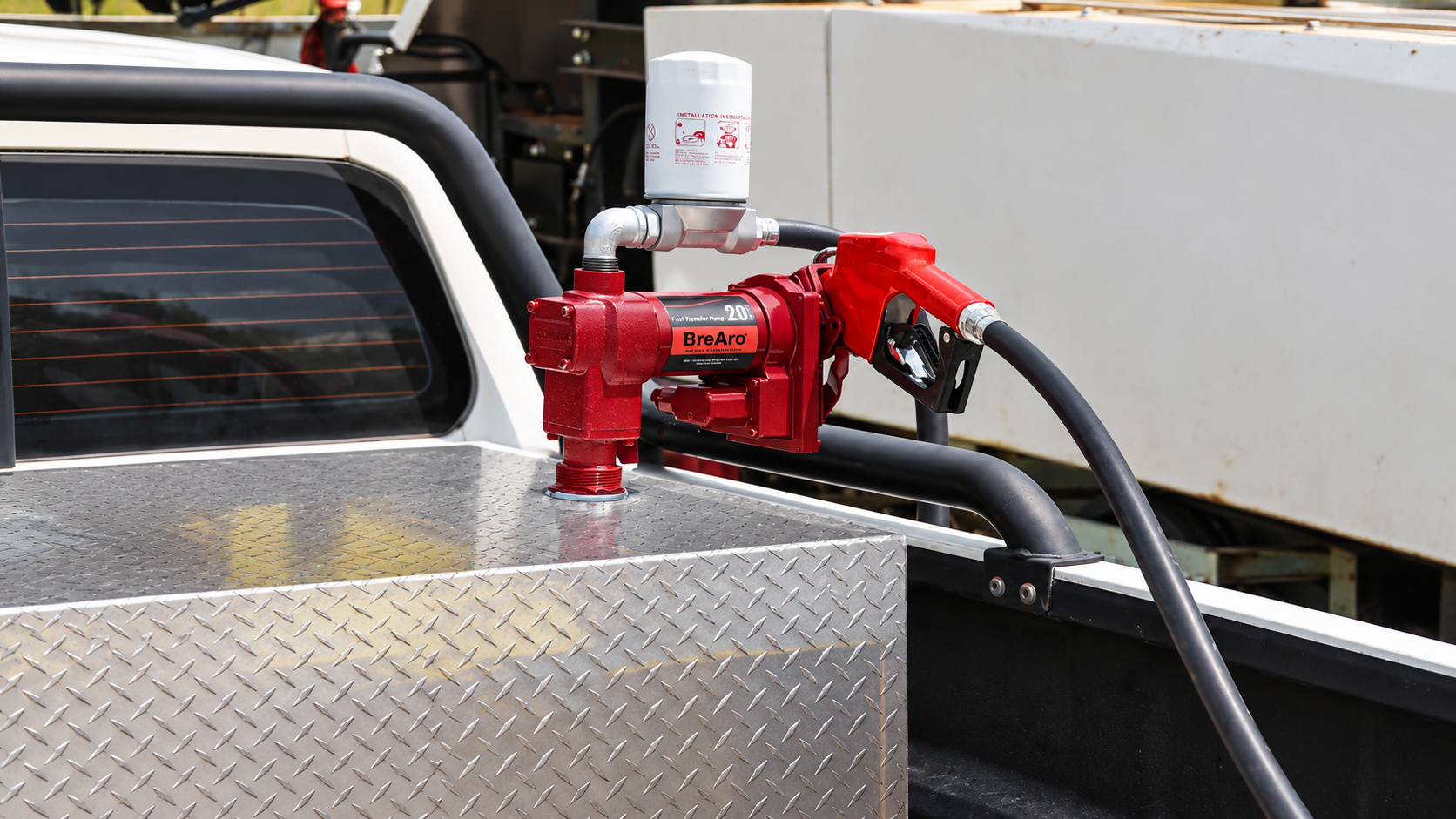 BreAro 20 GPM fuel transfer pump with filter and nozzle mounted on a pickup truck fuel tank
