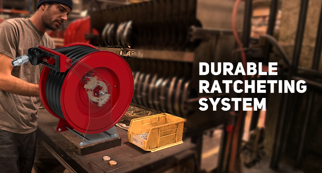 Worker using BreAro diesel fuel hose reel in an industrial workshop with a durable ratcheting system for secure hose control, ideal for heavy-duty fuel dispensing and shop environments.