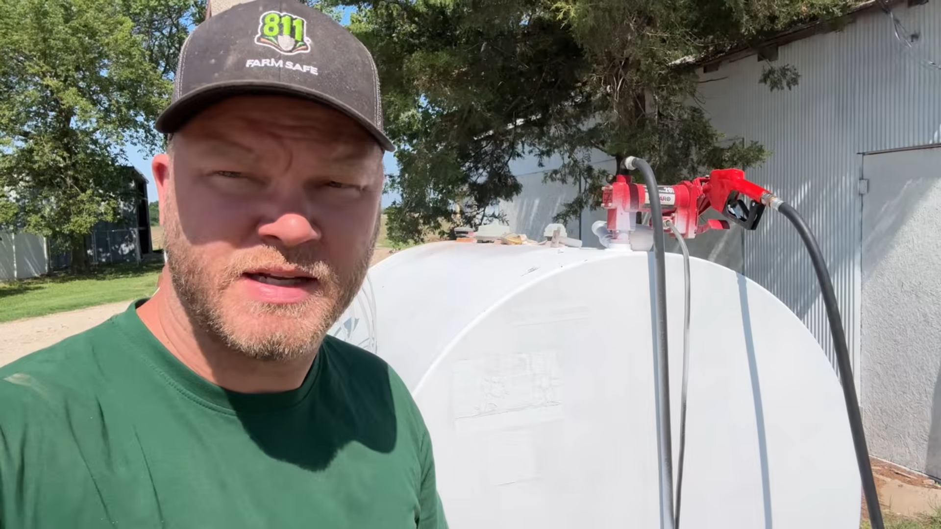 Farmer giving a testimonial with a Brearo diesel transfer pump installed on a farm fuel tank in the background.