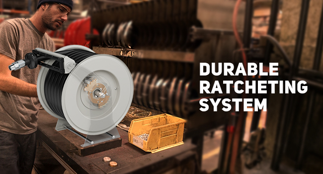 BreAro fuel hose reel with durable ratcheting lock system for secure hose positioning, shown in an industrial workshop environment.