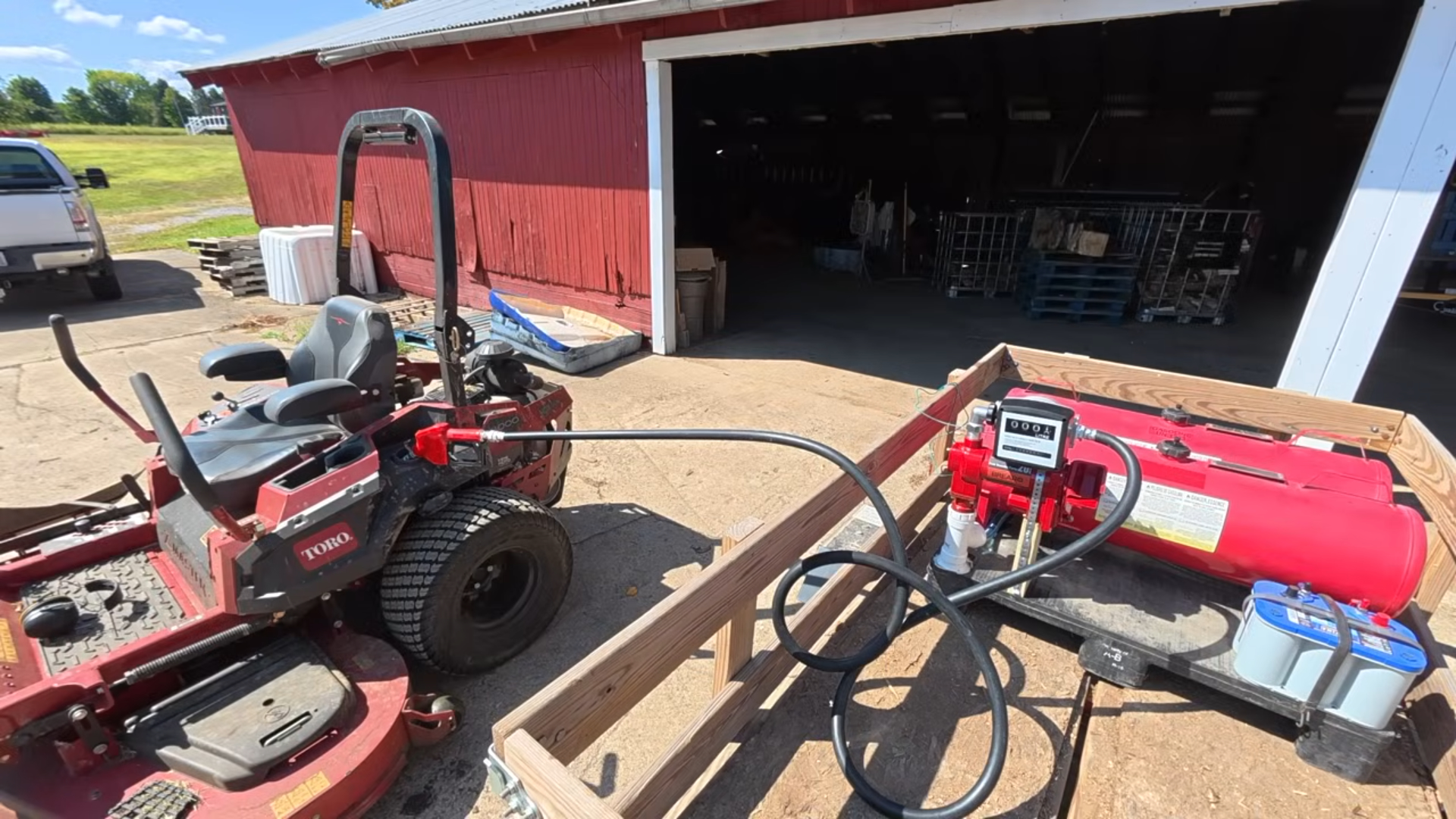 Brearo fuel transfer pump and tank setup refueling farm equipment in a real-world application.