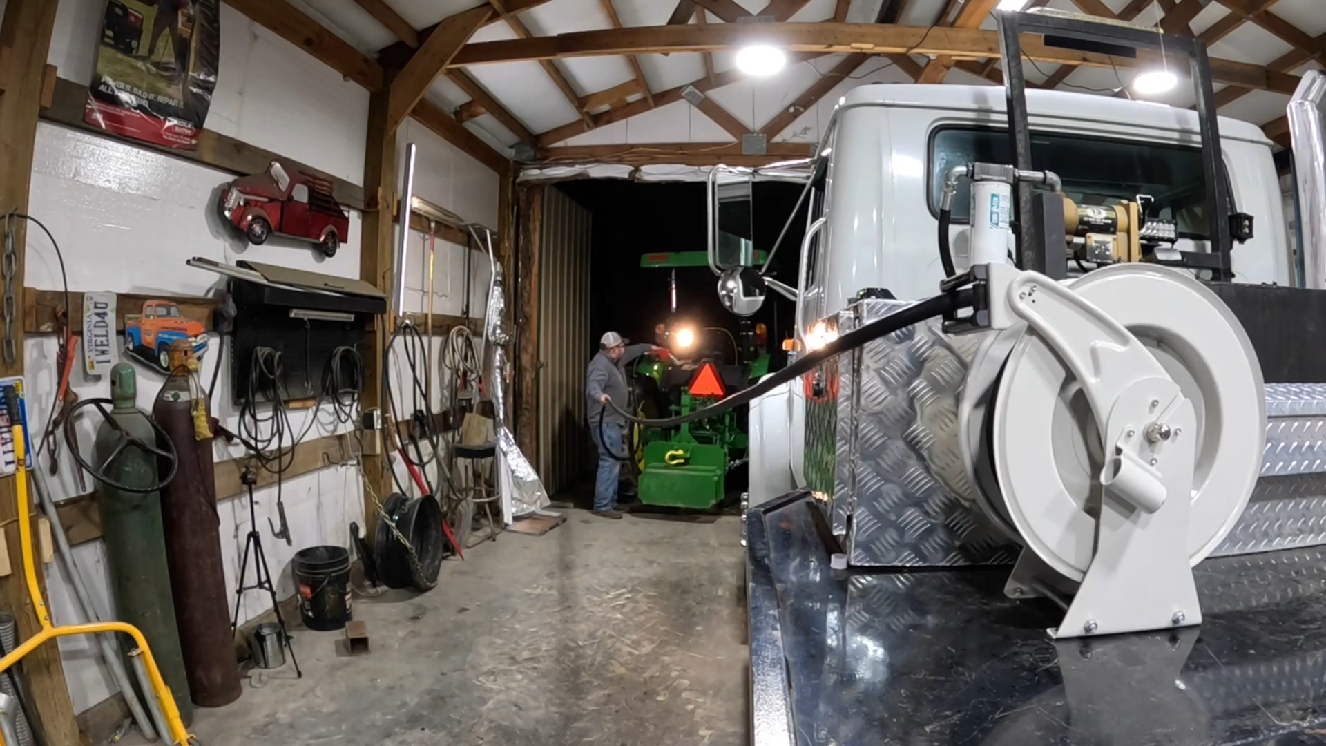 Brearo spring-driven fuel hose reel used for fueling in farm workshop