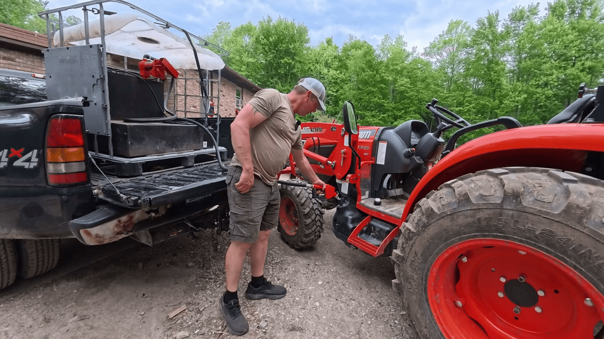 A person refueling a tractor using an automatic fuel transfer pump in an outdoor farm setting, showcasing the convenience and efficiency of the pump for agricultural equipment fueling.