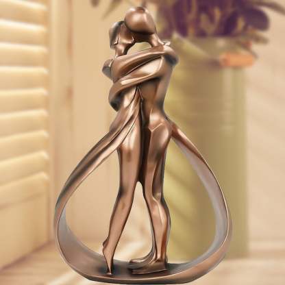 Romantic lovers embrace statue