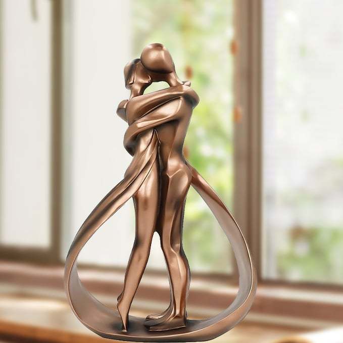 Romantic lovers embrace statue