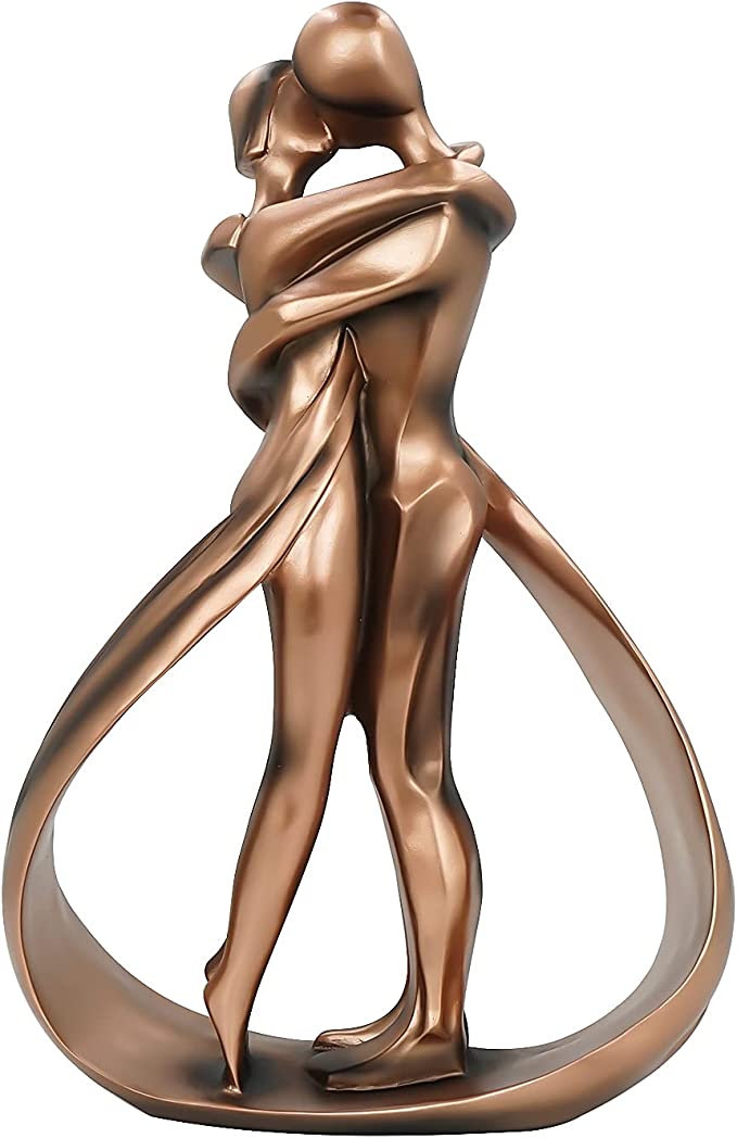 Romantic lovers embrace statue