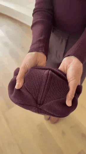 Woman demonstrating how to put on a ponytail beanie