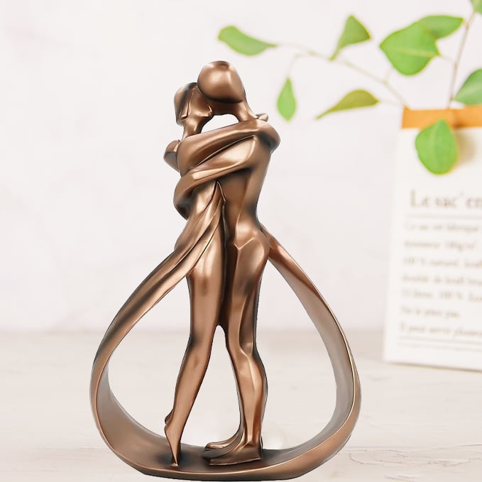 Romantic lovers embrace statue