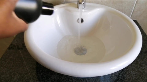 Add wig shampoo to the water and mix it