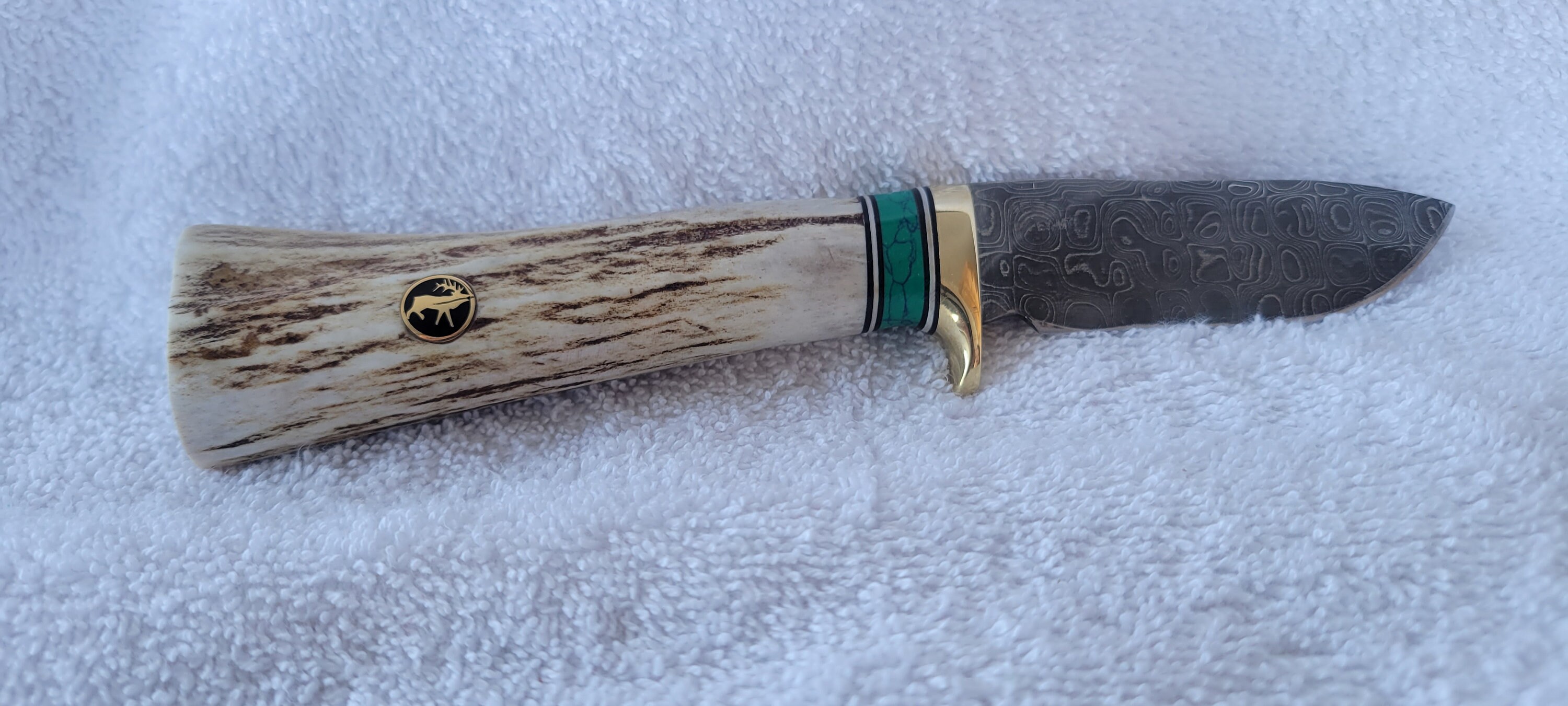 Made in Montana Handmade knife with Elk Antler, green spacer. Buffalo nickel in end cap.