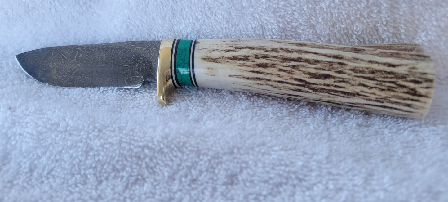 Made in Montana Handmade knife with Elk Antler, green spacer. Buffalo nickel in end cap.