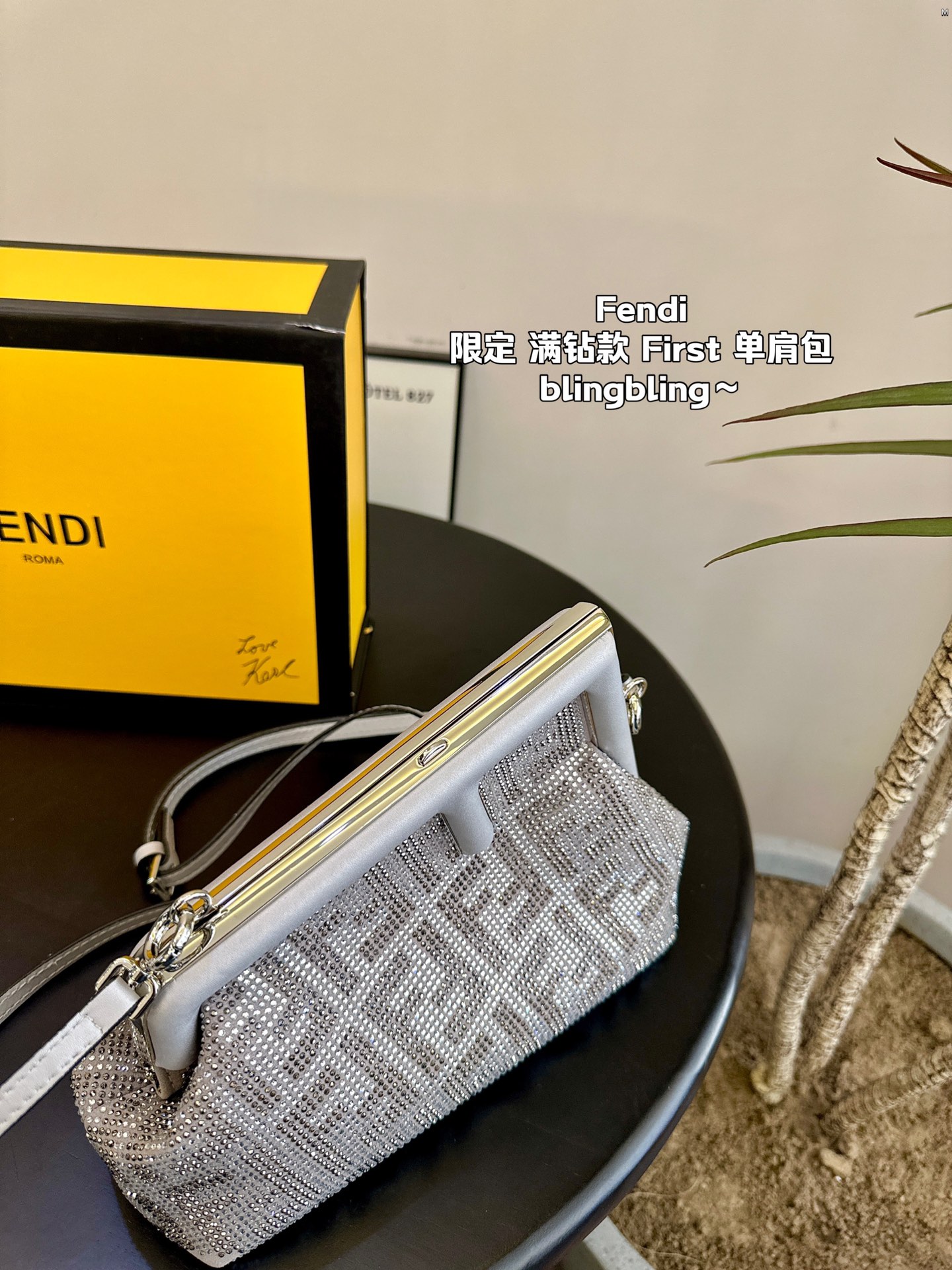 F-I Rhinestone with First shoulder bag in hand.