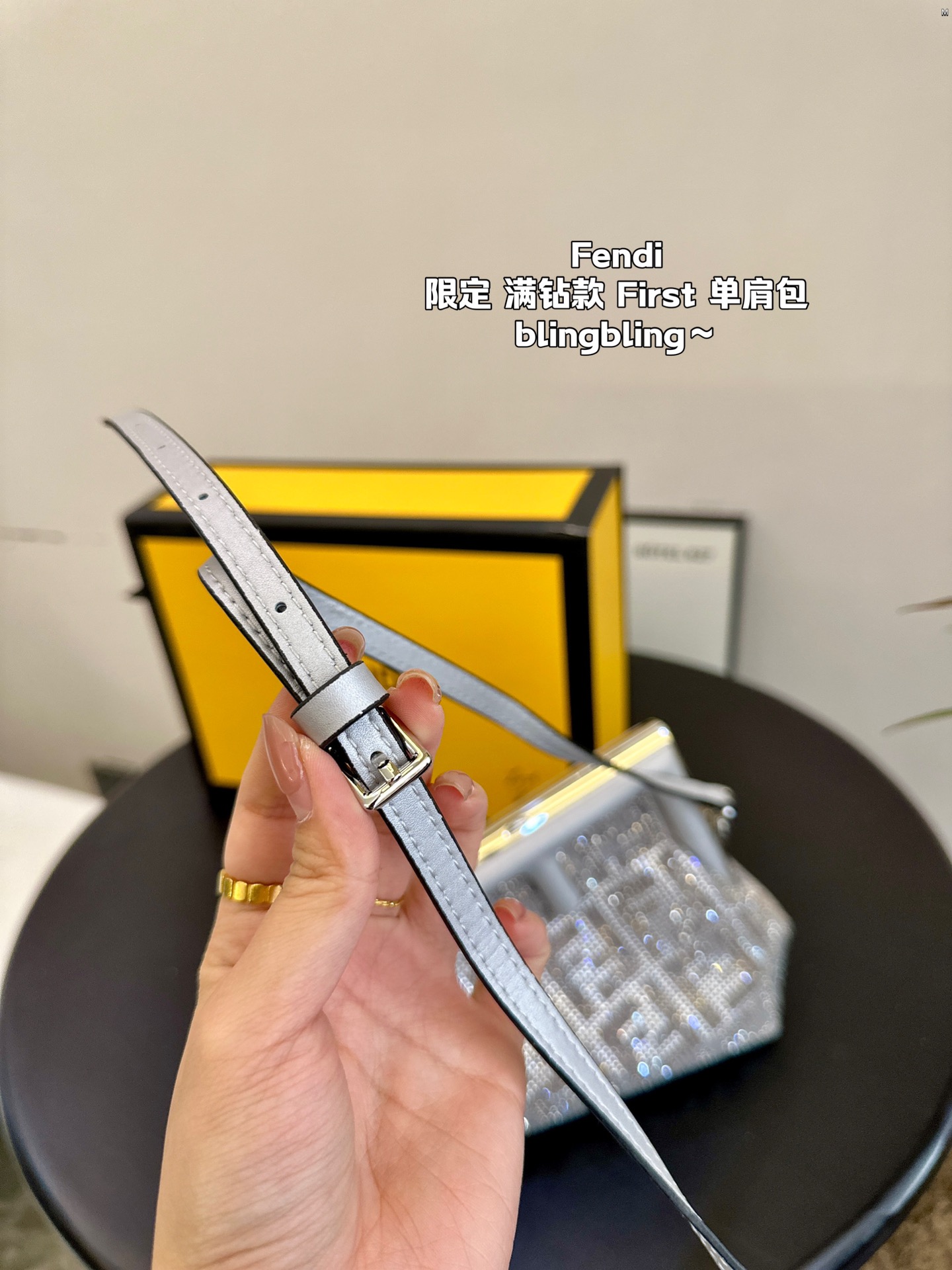 F-I Rhinestone with First shoulder bag in hand.