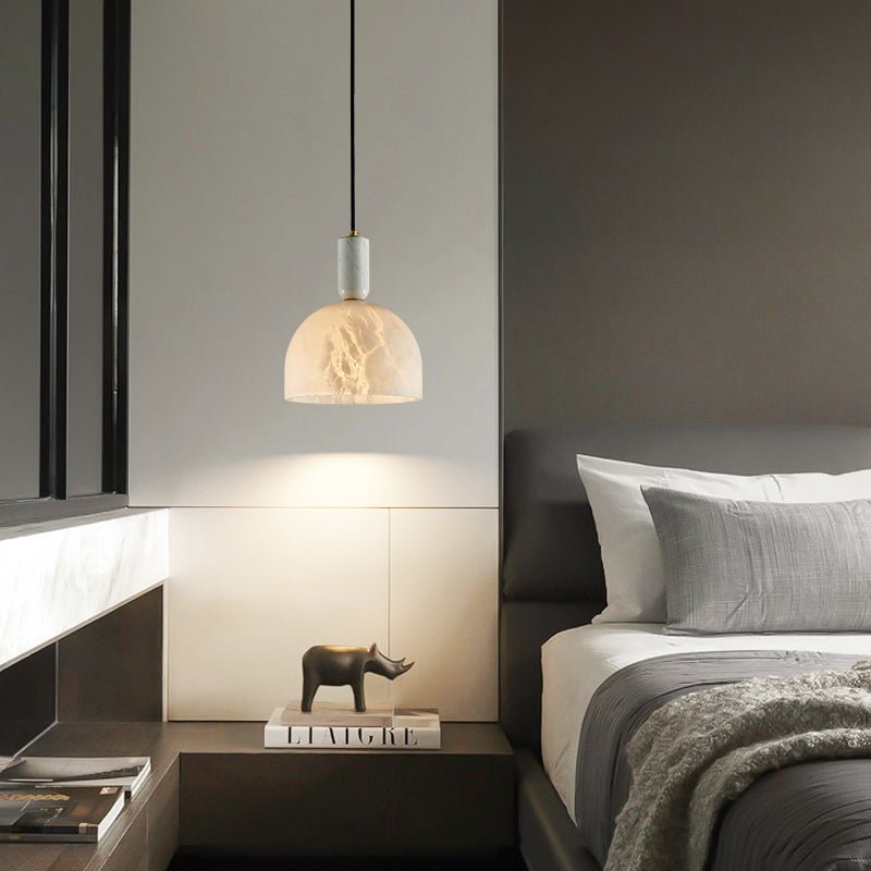 Altus alabaster pendant with a dome shade beside a bed