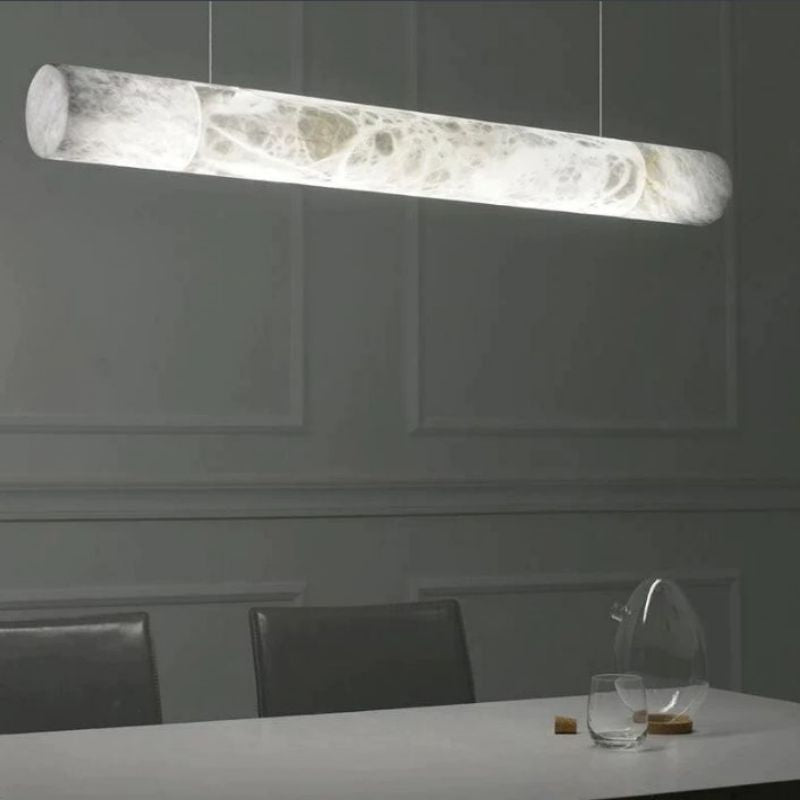 Sylvia alabaster linear pendant above a dining table