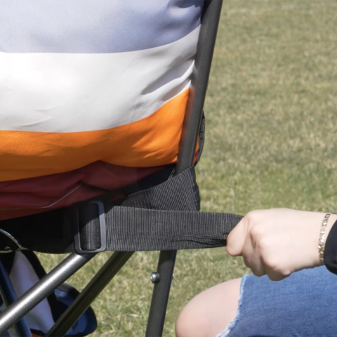 Tightening straps on back of chair.