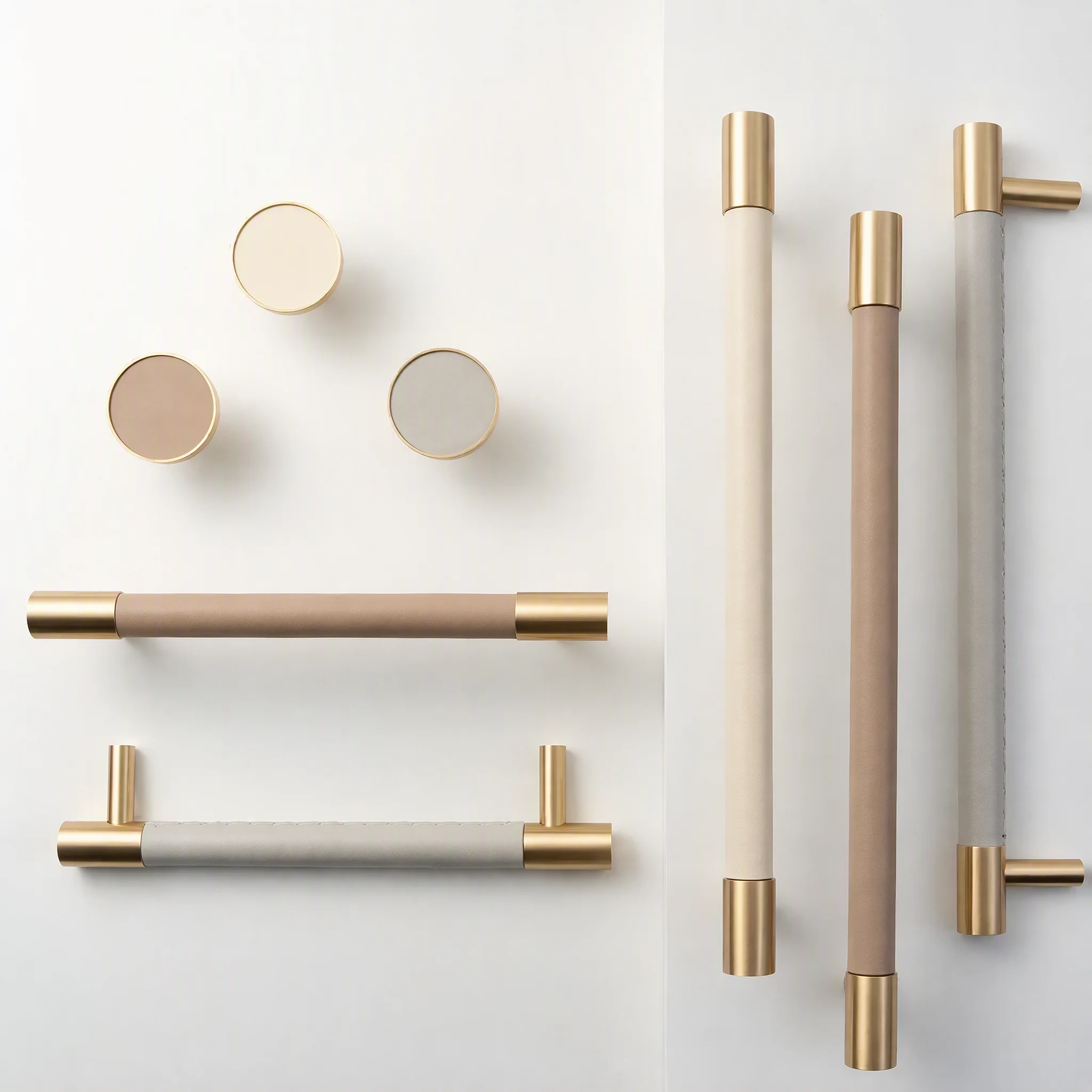 Leather cabinet handles and knobs with brass ends in khaki, taupe and light grey
