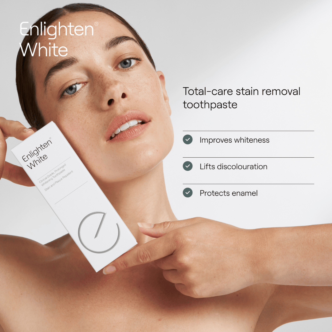 A woman holding the Enlighten White toothpaste box next to her face, with text reading "Total-care stain removal toothpaste." Benefits include improving whiteness, lifting discolouration, and protecting enamel. The minimalist design is complemented by a clean, white background.