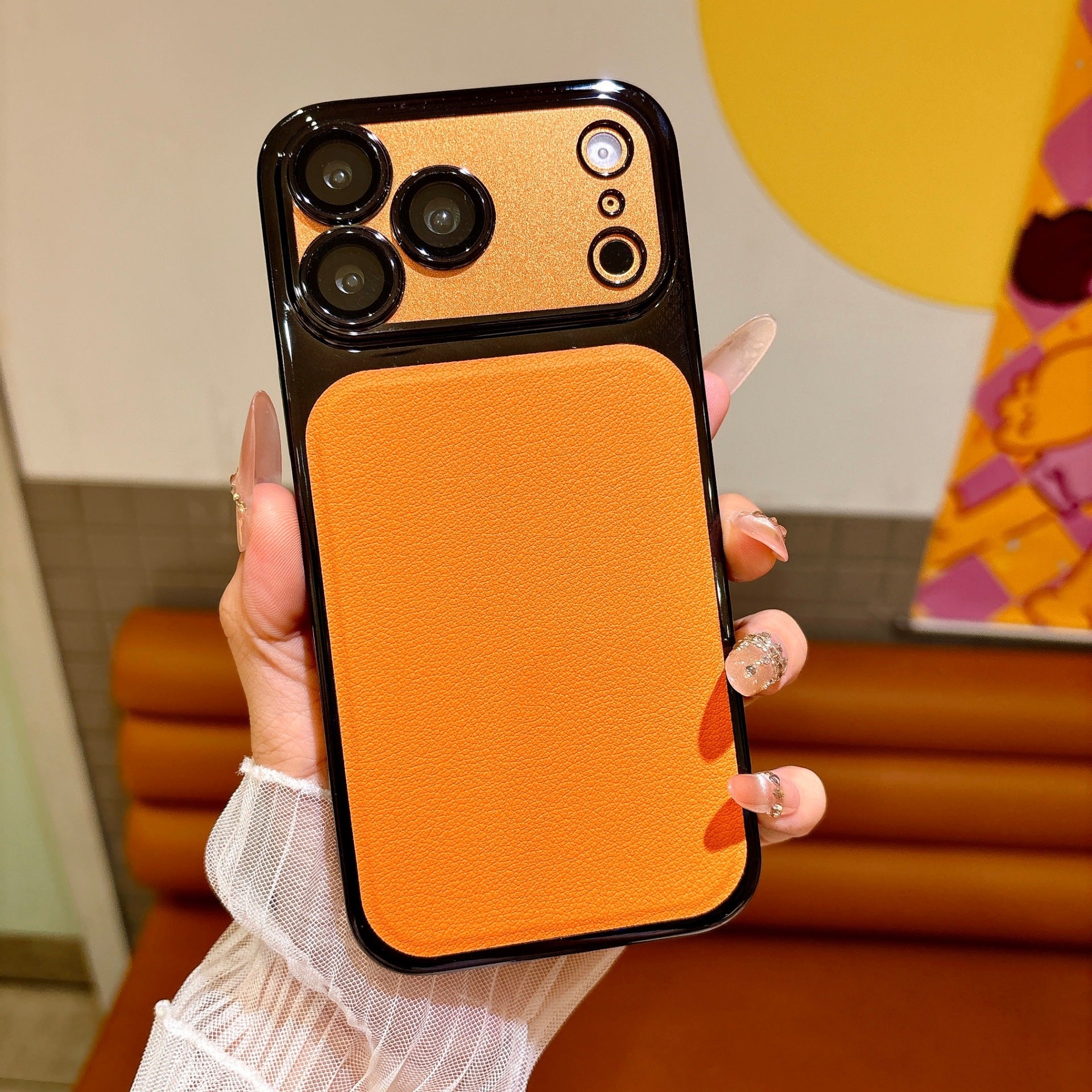 CASESUN Detailed view of the orange vegan leather back panel with fine litchi texture.