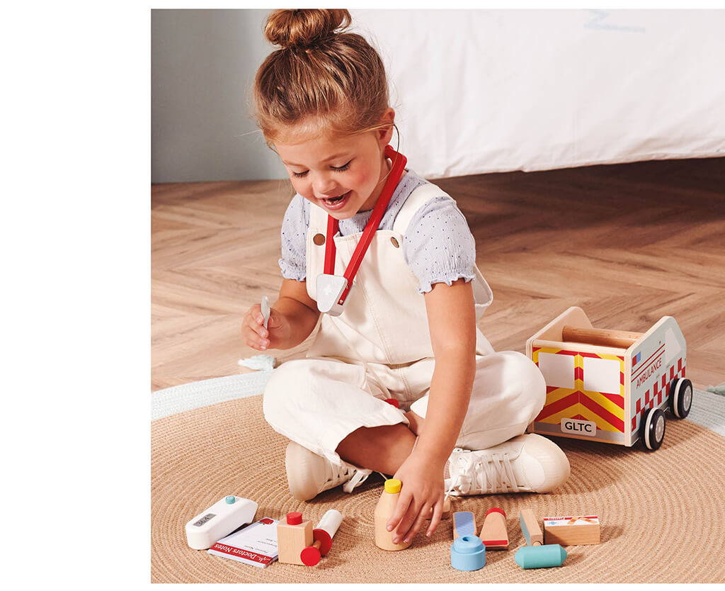 Young girl playing with Ambulance Toy Set