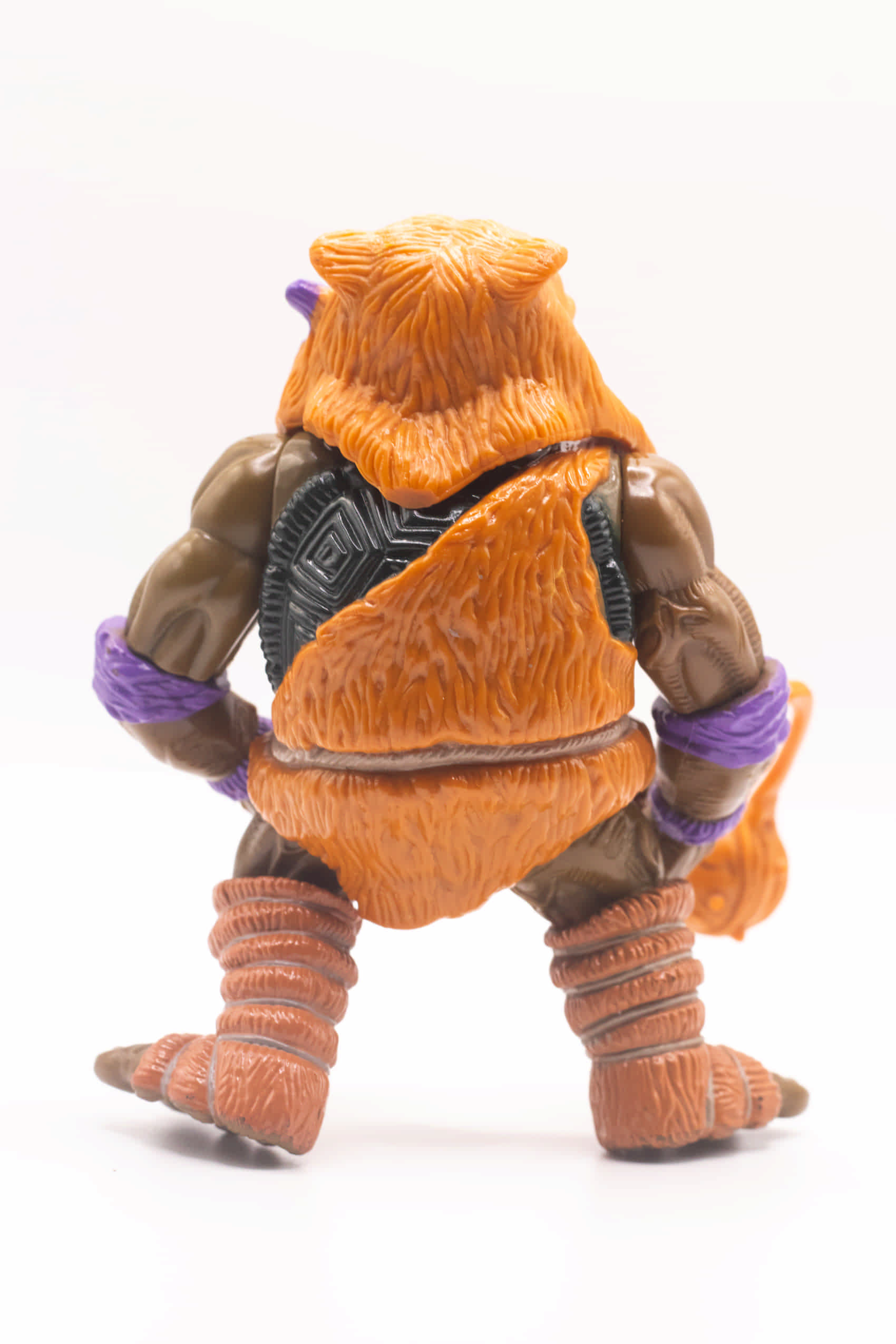 Rear shot of Cave-Turtle Don action figure showing sculpted fur outfit and shell detail
