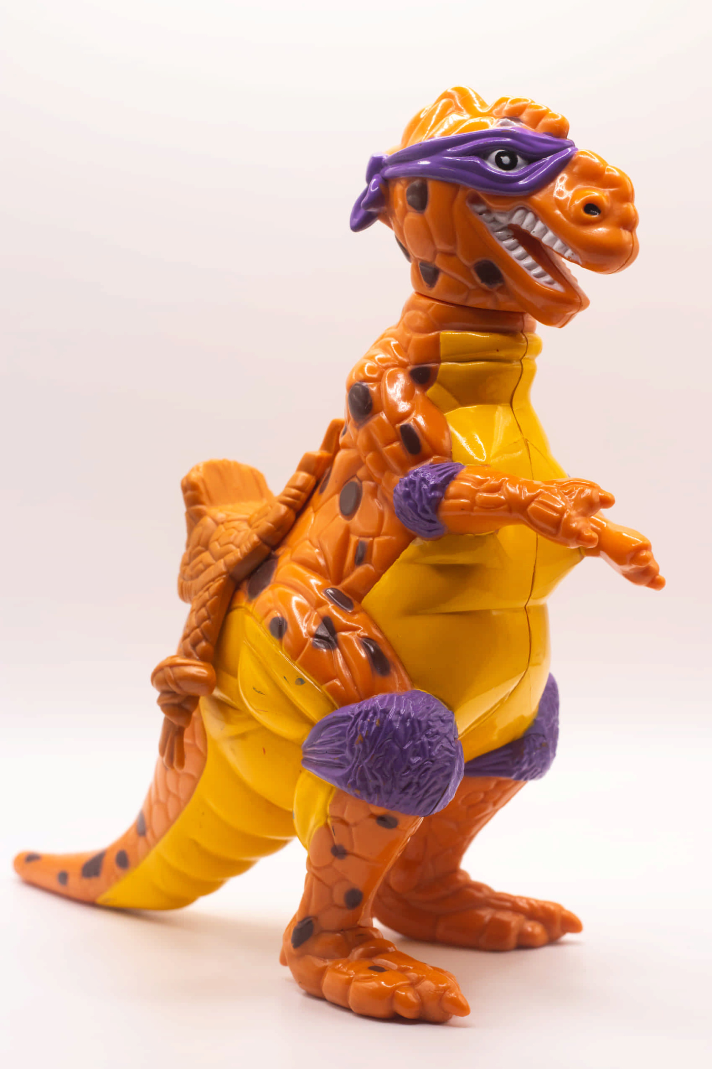 Front right side view of Trippy Tyrannosaurus with mounted saddle