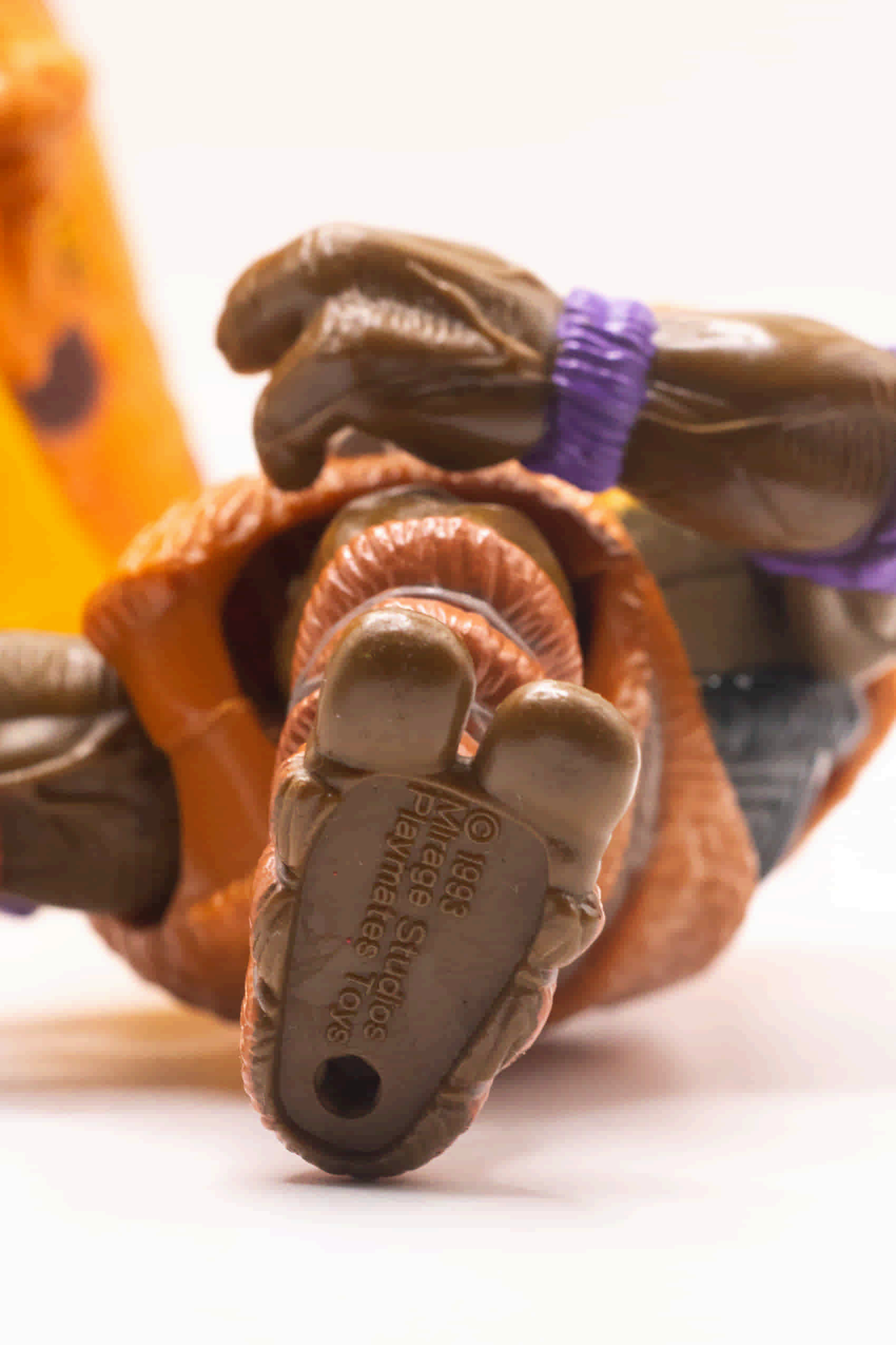 Close-up shot of Cave-Turtle Don's foot showing 1993 Mirage Studios stamp