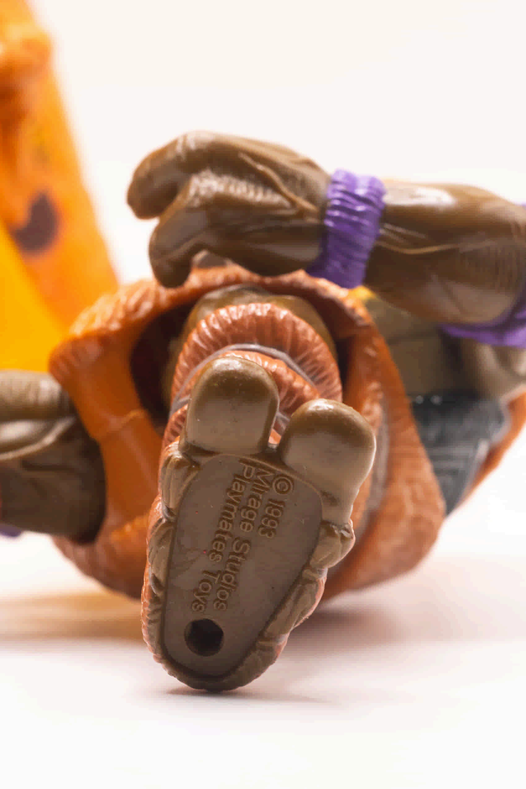 Close-up shot of Cave-Turtle Don's foot showing 1993 Mirage Studios stamp