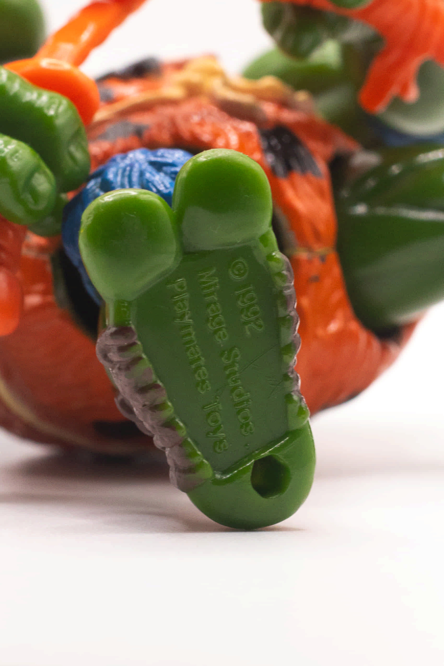 Close-up shot of Cave-Turtle Leo's foot showing 1992 Mirage Studios stamp