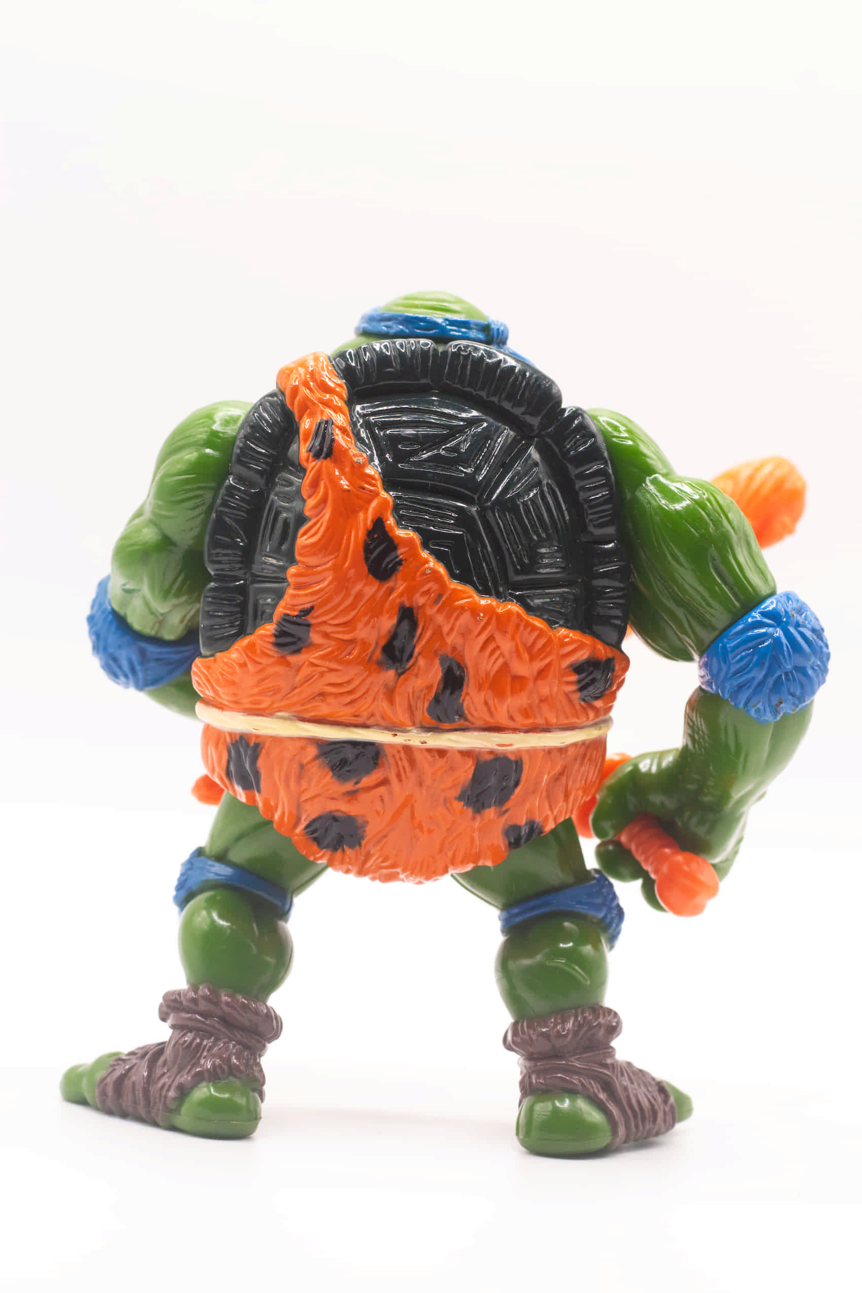 Rear view shot of vintage Cave-Turtle Leo action figure holding katana and club
