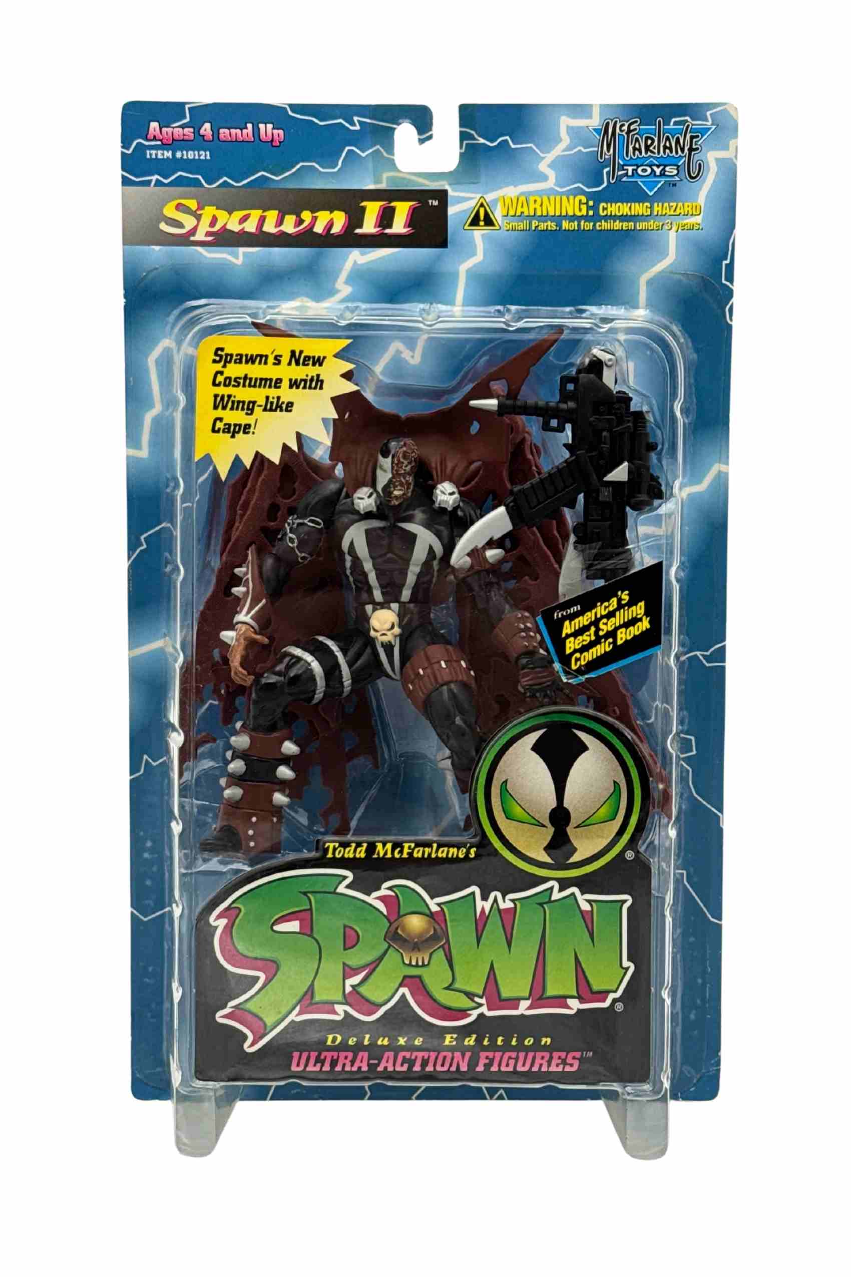 Front carded shot of Spawn II action figure with wing-like red cape, skull belt and rifle accessory in lightning card blister packaging