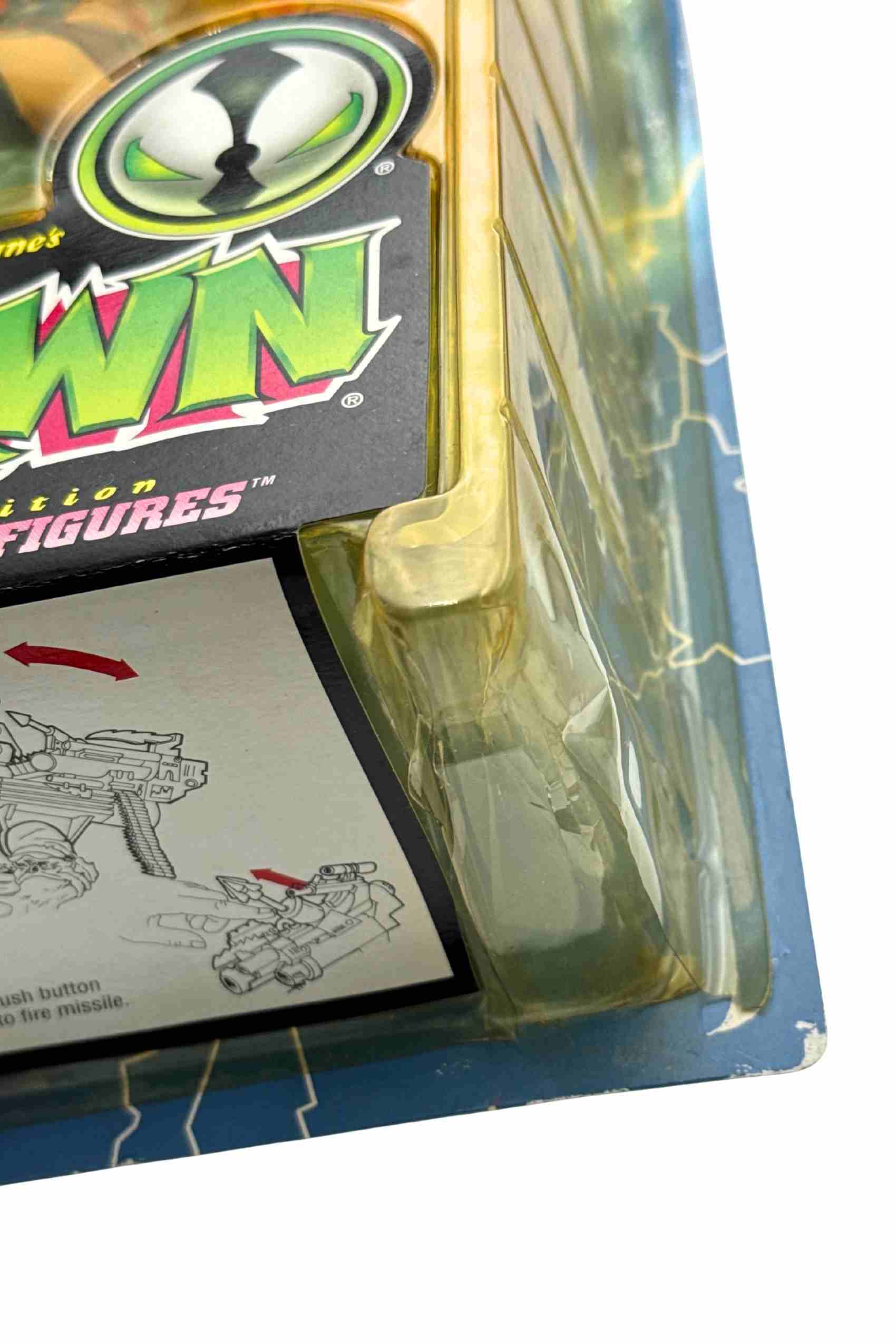 Corner detail shot of Clown II Spawn action figure blister edge with yellowing and minor card wear