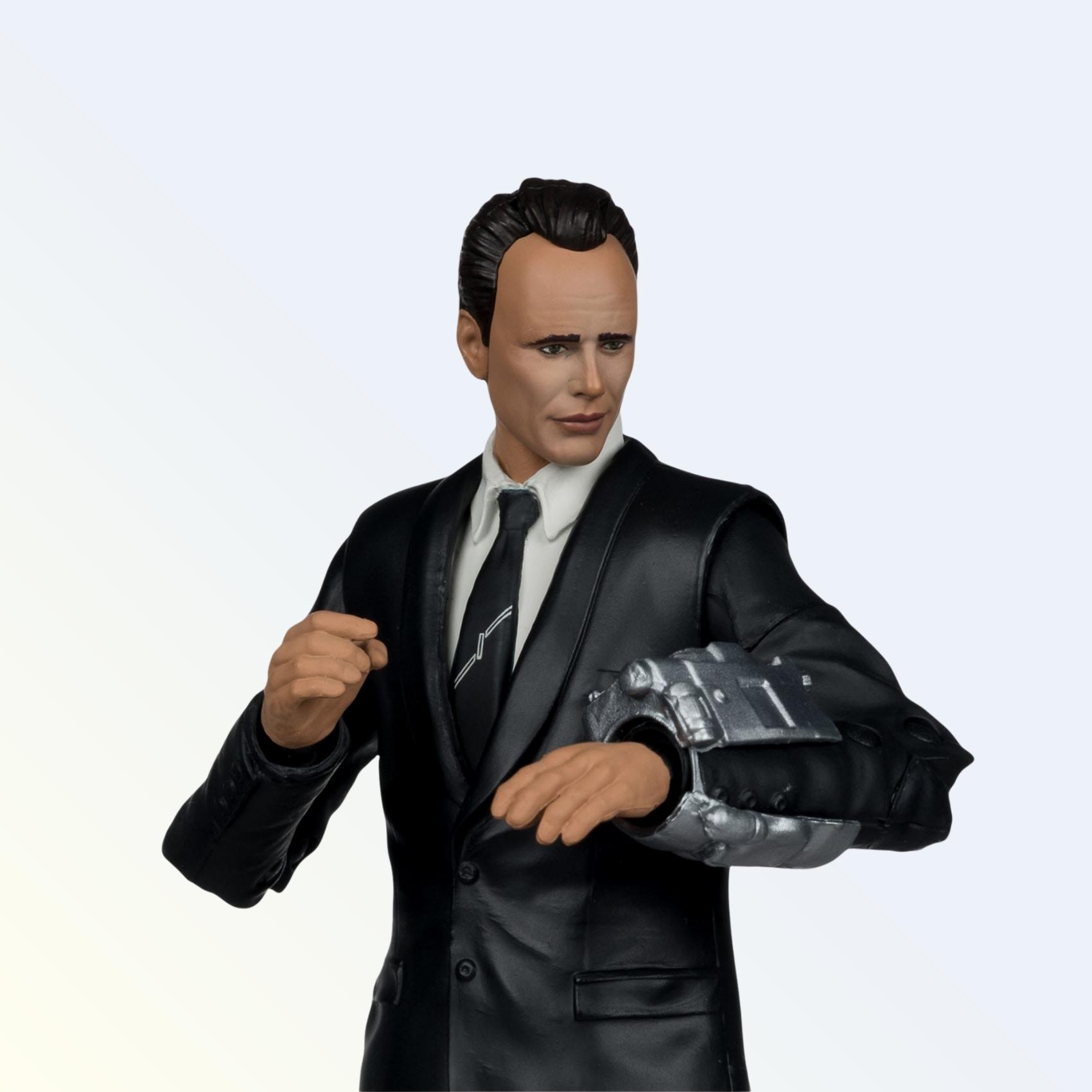Close-up shot of Cooper Howard action figure in black suit with Pip-Boy on wrist