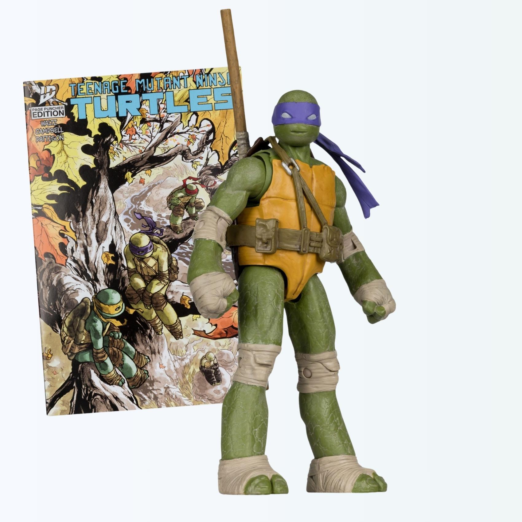 Front-facing hero shot of Donatello action figure posed with bo staff in front of Page Puncher Edition comic